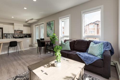 a living room with a couch and a table at Free Heated Parking, Close to DT, Pet Friendly in Calgary