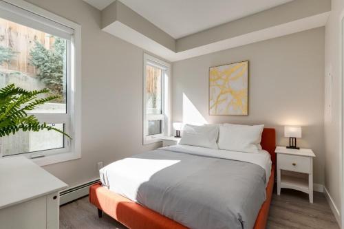 a bedroom with a large bed and a window at Free Heated Parking, Close to DT, Pet Friendly in Calgary