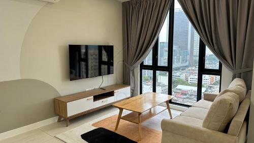 a living room with a couch and a tv at Sentral 108 Home Brickfields Bangsar Kuala Lumpur 2-5Pax in Kuala Lumpur