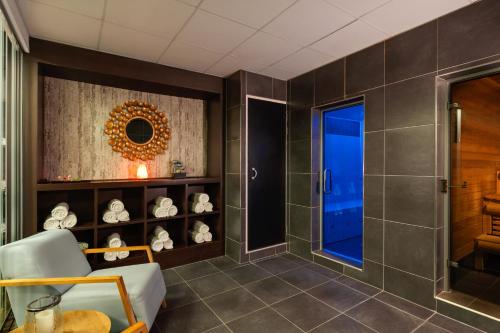 a bathroom with a shower and a glass door at Novotel London Tower Bridge in London