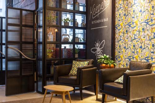 a waiting room with two chairs and a table at Novotel London Tower Bridge in London