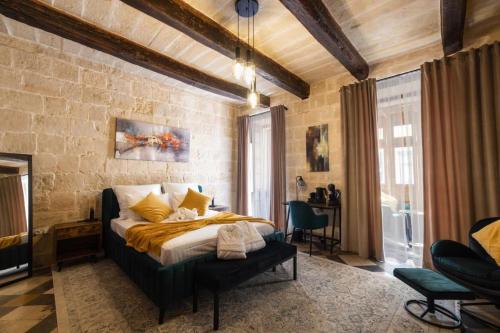 a bedroom with a large bed in a room at Knights 1500s Palazzino in Valletta - Seaview Rooftop Jacuzzi lounge in Valletta