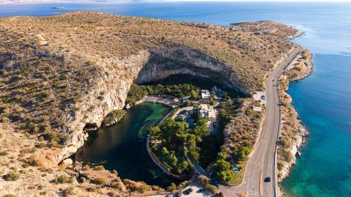 an aerial view of a cave in the side of a mountain at Athenian Riviera Hotel& Suites in Athens