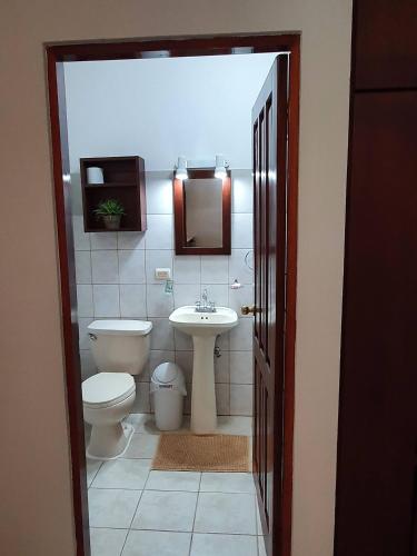 a bathroom with a toilet and a sink at Marina Loft Condos 212 in Coco