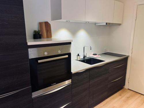 a kitchen with a sink and a stove at Cozy Flats Silkeborg - S3 in Silkeborg