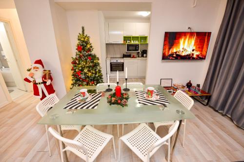 a christmas tree in a kitchen with a table and a santa at Bucharest Accommodation Apartments in Bucharest