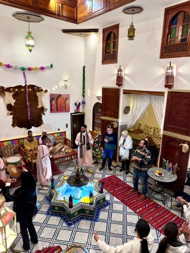 a group of people standing in a living room at Riad Hamad Tijani in Fès
