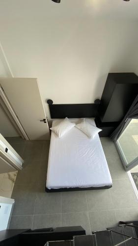 a bedroom with a white bed in a room at Akrogiali Apartments in Barbati