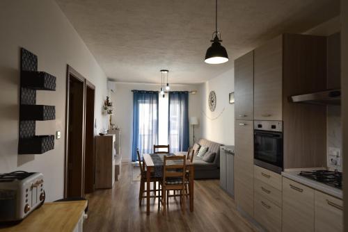 a kitchen and living room with a table and chairs at Sea Breeze Nest in St Paul's Bay