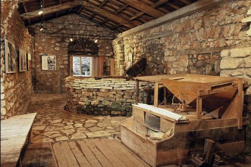 a stone room with a stove in a stone wall at Terra Petra Villa at Psari Trikolonon Gortynia in Psárion