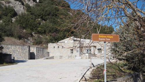 a street sign in front of a stone building at Terra Petra Villa at Psari Trikolonon Gortynia in Psárion