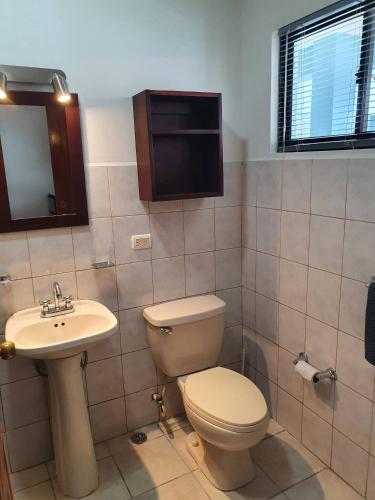 a bathroom with a toilet and a sink at Marina Loft Studio 224 in Coco