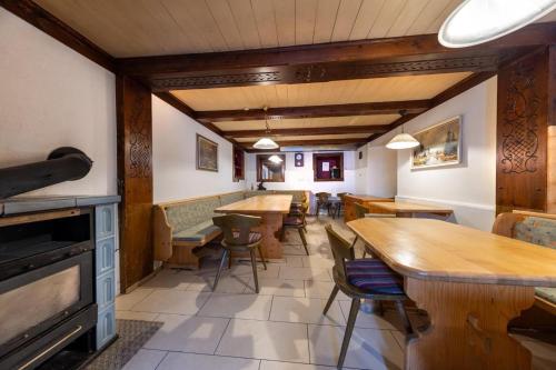 a restaurant with tables and chairs in a room at Haus Eckhausl Family in Bramberg am Wildkogel