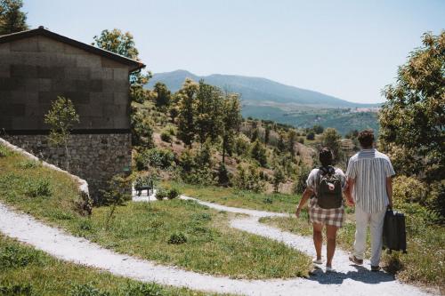 a man and a woman walking down a dirt road at Estrela Serenity - Resort in Folgosinho
