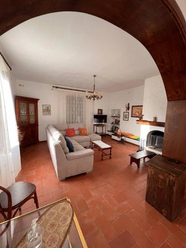 a living room with a couch and a fireplace at All'Acqua Santa, immersi nella natura in Semproniano
