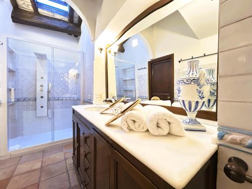 a bathroom with two sinks and a shower at The Gem - Trastevere Cozy Retreat with pool in Rome