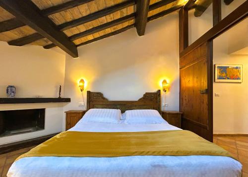 a bedroom with a large bed with a fireplace at The Gem - Trastevere Cozy Retreat with pool in Rome