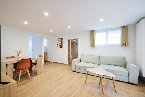un salon avec un canapé et une table dans l'établissement L'Évasion Relaxante Sauna et Spa privé, à Orsay