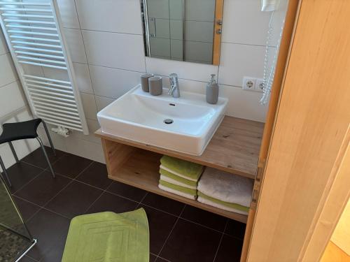 a bathroom with a sink and a mirror at Schweinberger Sixtus in Aschau