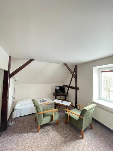 a bedroom with a bed and a table and chairs at Willa Szwadron in Łańcut