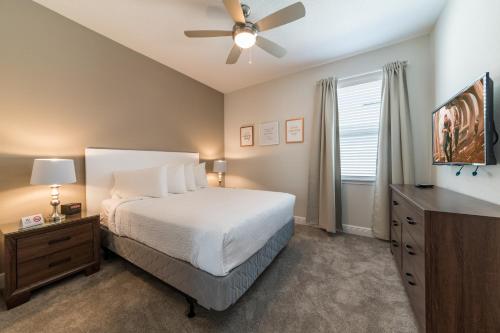 a bedroom with a bed and a ceiling fan at Charming Home With Private Pool Near Disney With Water Park & Resort Access At Encore Resort - 7489Mr in Kissimmee