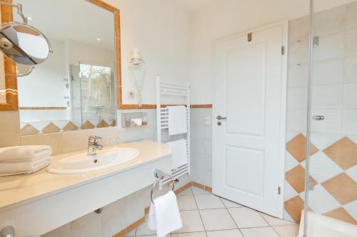 a bathroom with a sink and a shower at Ferienwohnungen Dünenmeer in Dierhagen