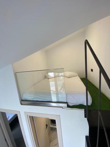a bed in a room with a glass ceiling at Akrogiali Apartments in Barbati