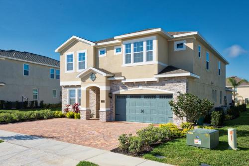 a house with a garage in front of it at Grand Home Near Disney With Private Pool, Media And Themed Rooms With Waterpark & Resort Access At Encore Resorts Reunion - 360Bu in Orlando
