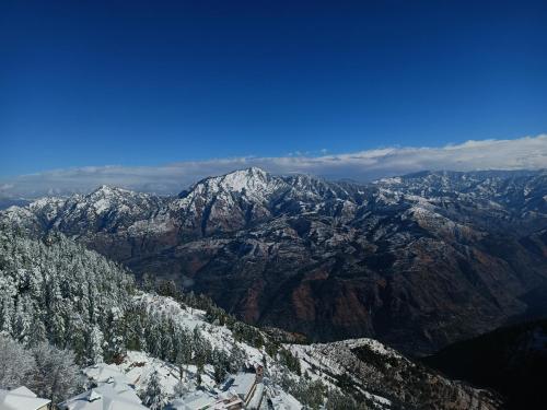 a view of a mountain range with snow covered mountains at Hostie Mystica - 3BHK luxury apartment, Mashobra, Shimla in Shimla