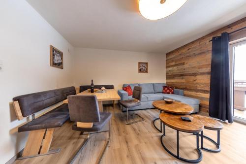 a living room with a couch and a table at Haus Eckhausl Family in Bramberg am Wildkogel