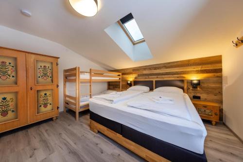a bedroom with a bed and a bunk bed at Haus Eckhausl Family in Bramberg am Wildkogel
