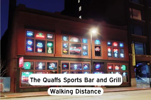 a building with a sign that reads the outlets sports bar and grill walking distance at Chic 1BR Parking, Rooftop, Near Arrowhd & TMobile in Kansas City