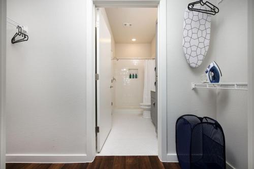 Un baño con una puerta abierta a un baño con inodoro. en 1BR Escape w Pool&Parking, Near Rvrwlk & Conv Ctr, en San Antonio