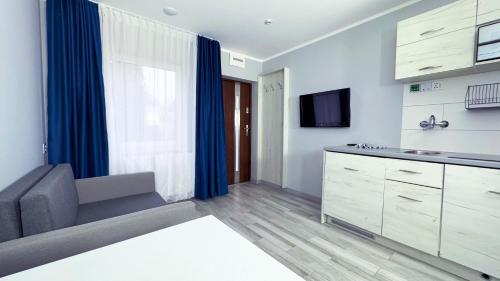 a kitchen with a couch and a tv in a room at A2 autostrada highway close to Warszawa in Słomków