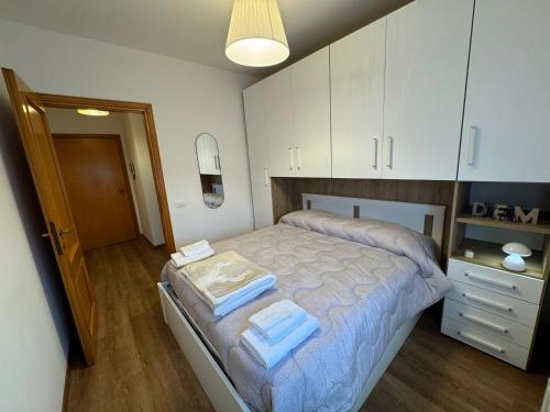 a bedroom with a bed with blue towels on it at Attico - Terrazza su Castello in Castel di Sangro