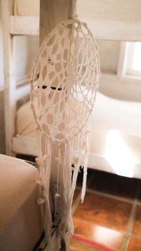 a white lace vase sitting next to a couch at Salty House Cabo Polonio in Cabo Polonio
