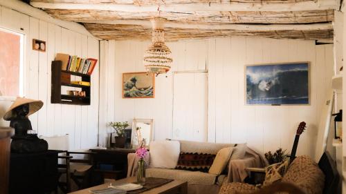 a living room with a couch and a table at Salty House Cabo Polonio in Cabo Polonio