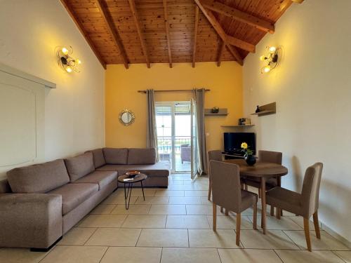a living room with a couch and a table at Villa Neptune in Kefallonia
