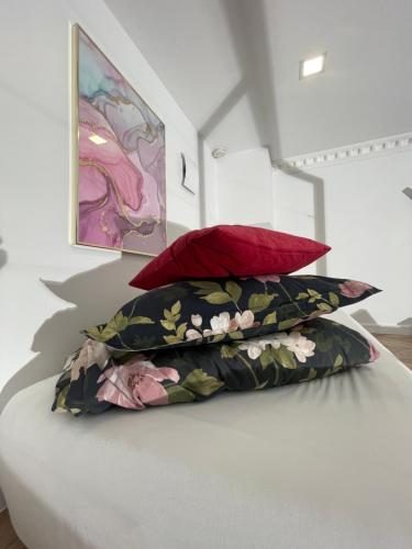 a pile of pillows sitting on top of a bed at Loft z Antresolą i Balkonem w Centrum Łodzi Przystań Jednorożca Klimatyzacja Faktura in Łódź