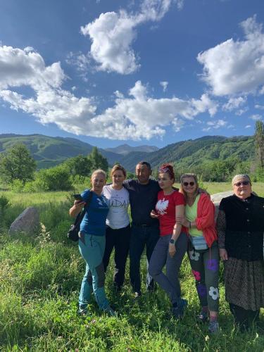 a group of people posing for a picture in a field at Kordon guest house in Krasnyy Most