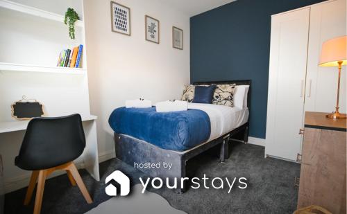 a bedroom with a bed and a desk and a chair at Clarice House by YourStays, 3 bedroom house by University of Staffordshire in Stoke on Trent