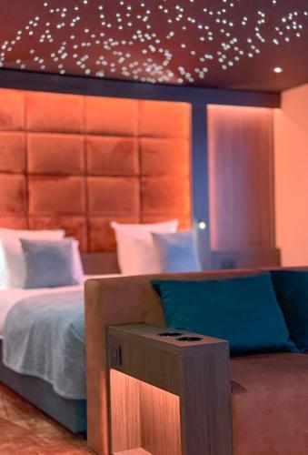 a bedroom with a large bed and a night stand at Hotel Restaurant Van Der Valk Nivelles-Sud in Nivelles