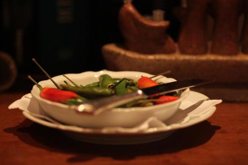 a bowl of vegetables on a plate on a table at Hotel Cala Del Porto in Vibo Valentia Marina