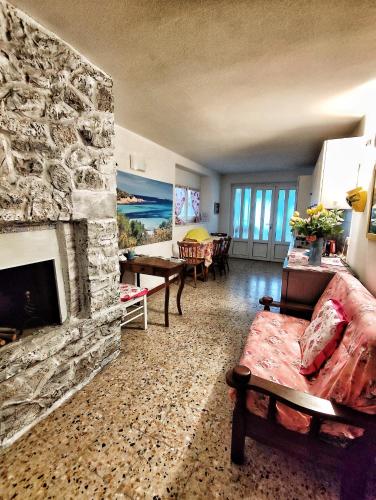 a living room with a stone fireplace and a couch at B&B Terramare in Montiano