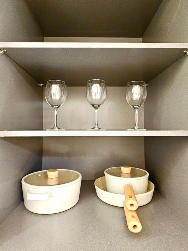 a shelf with wine glasses and bowls on it at Cookie House in Seoul