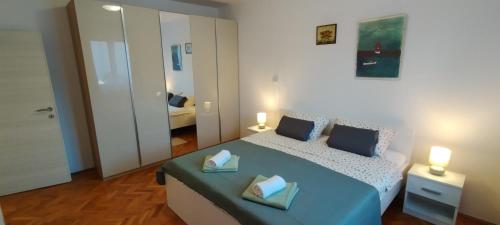 a bedroom with a bed with two pillows on it at Apartment Lovor in Krk