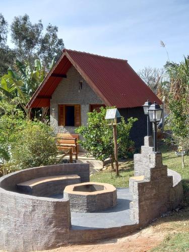 a small house with a building with a fire pit at Pousada Turmalina in Bueno Brandão