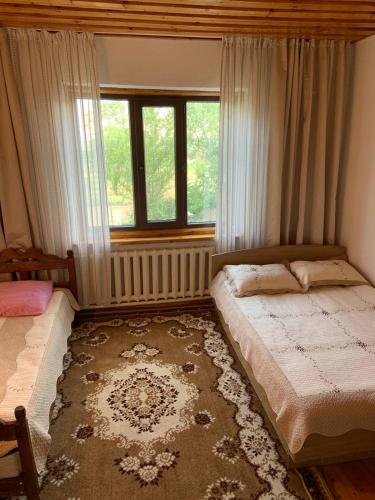 a bedroom with a bed and a window at Kordon guest house in Krasnyy Most