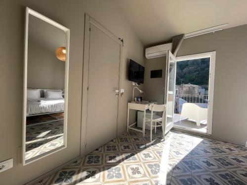 a bedroom with a mirror and a bed and a desk at Moronero in Ragusa