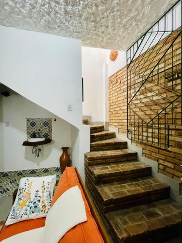 an orange couch in a room with a staircase at Casa Pau Brasil in Prado